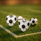 Melchior Jewellery heart-shaped football earrings for girls in black and white on grass