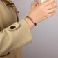 Melchior Jewellery fully magnetic floral bracelet copper engraved bangle worn on wrist with beige coat