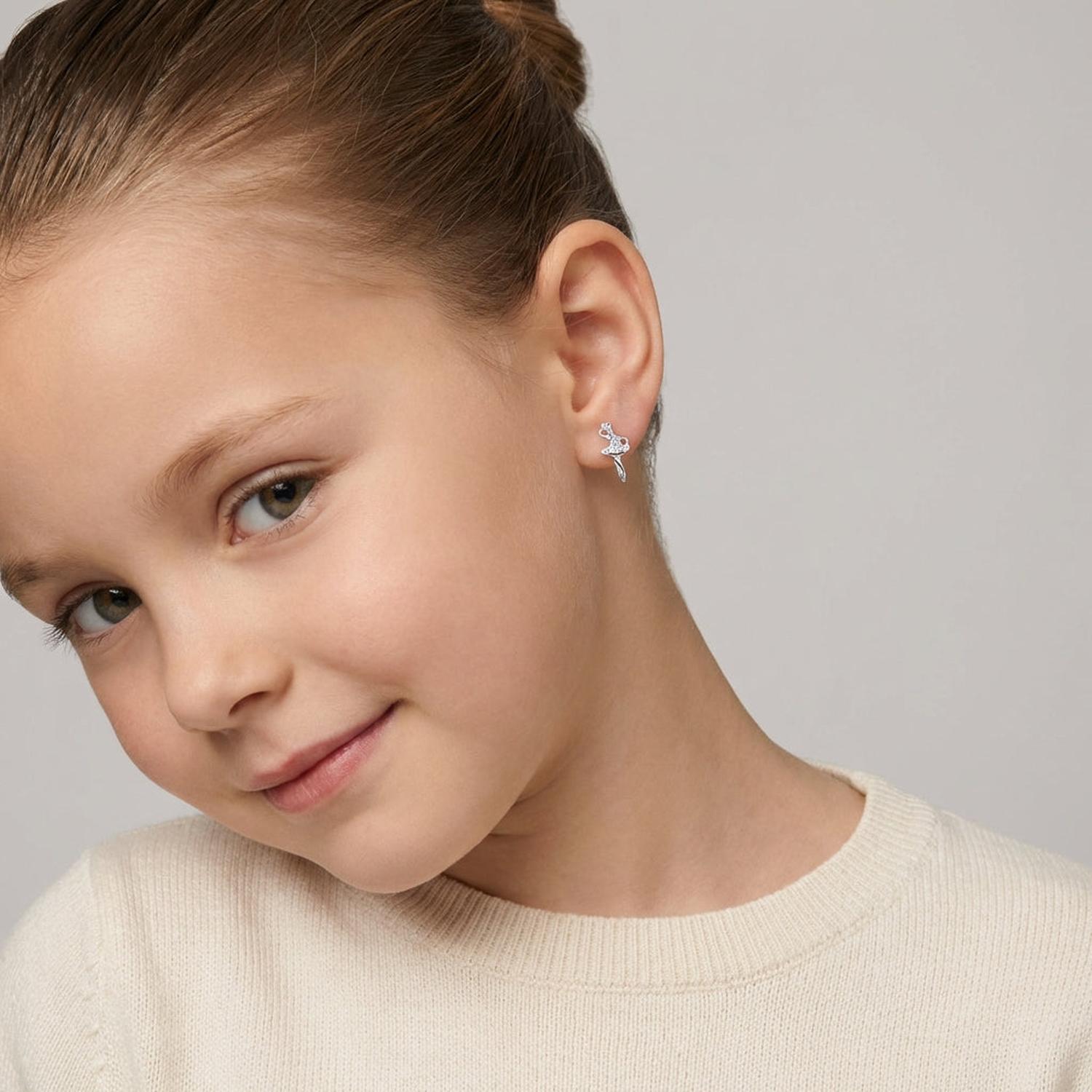 Melchior Jewellery girls ballet dancer earrings worn by young girl with hair in bun and cream sweater