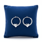 Melchior Jewellery girls heart charm hoop earrings in silver displayed on blue cushion