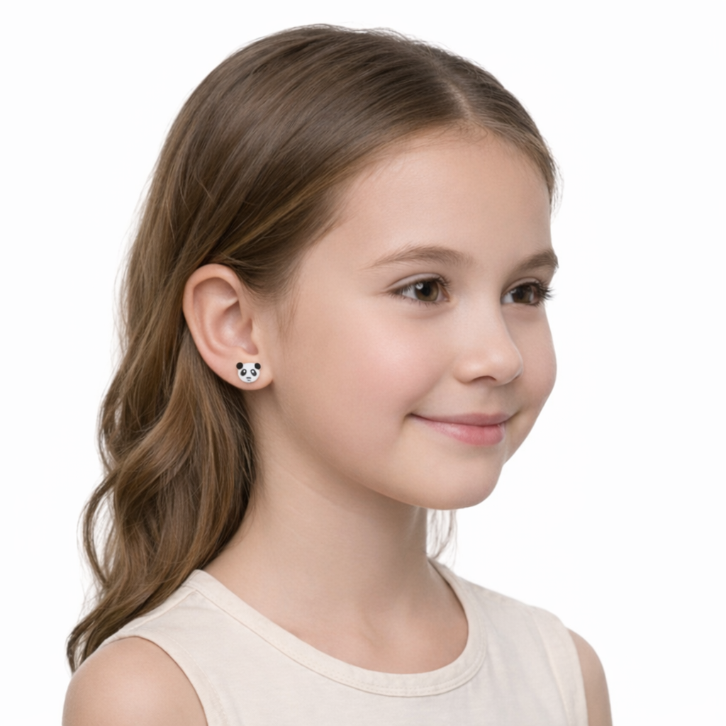 Young girl wearing Melchior Jewellery Girls Panda Earrings in white and black enamel with smiling face design