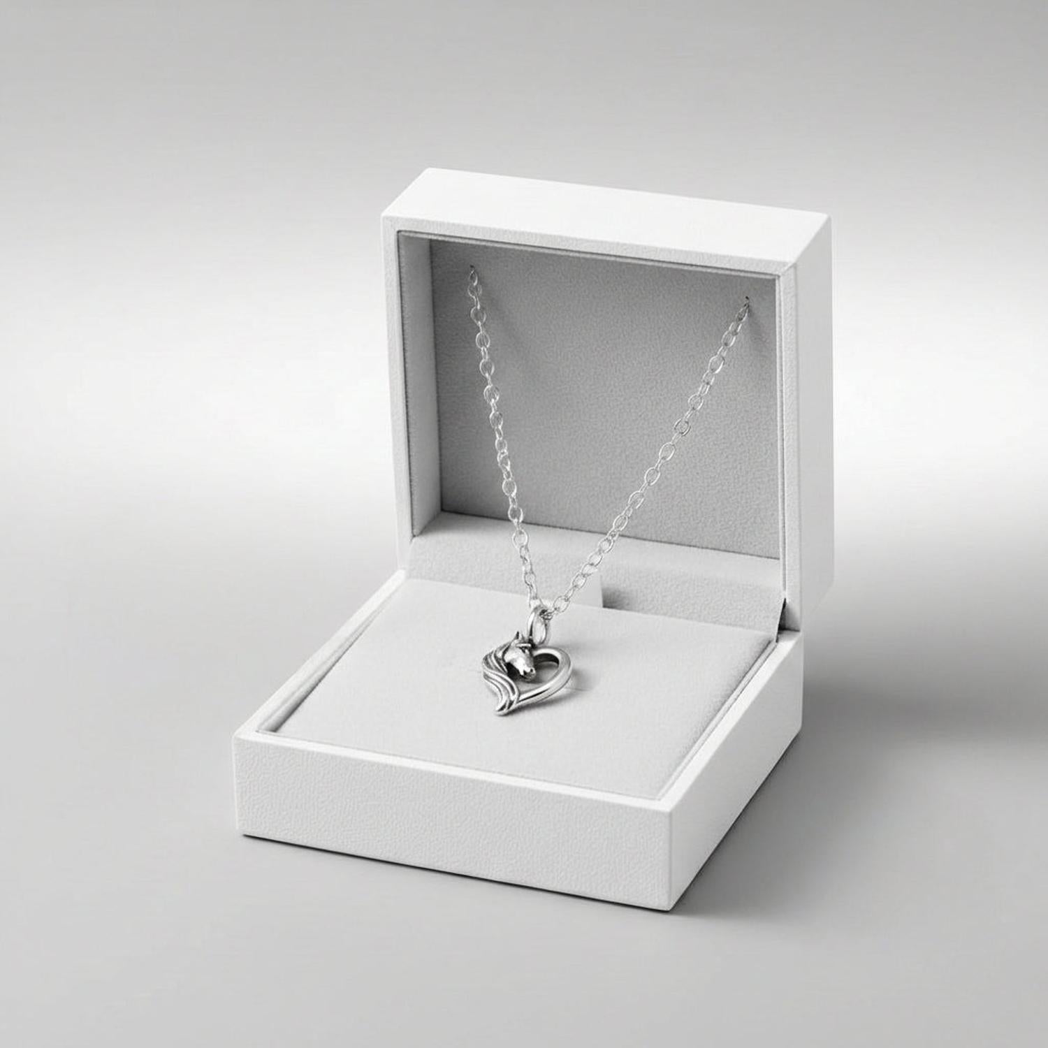 Girls silver horse necklace by Melchior Jewellery with horse pendant inside white jewellery box