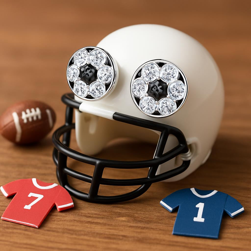 Girls sterling silver football earrings with crystal detailing displayed on a miniature football helmet