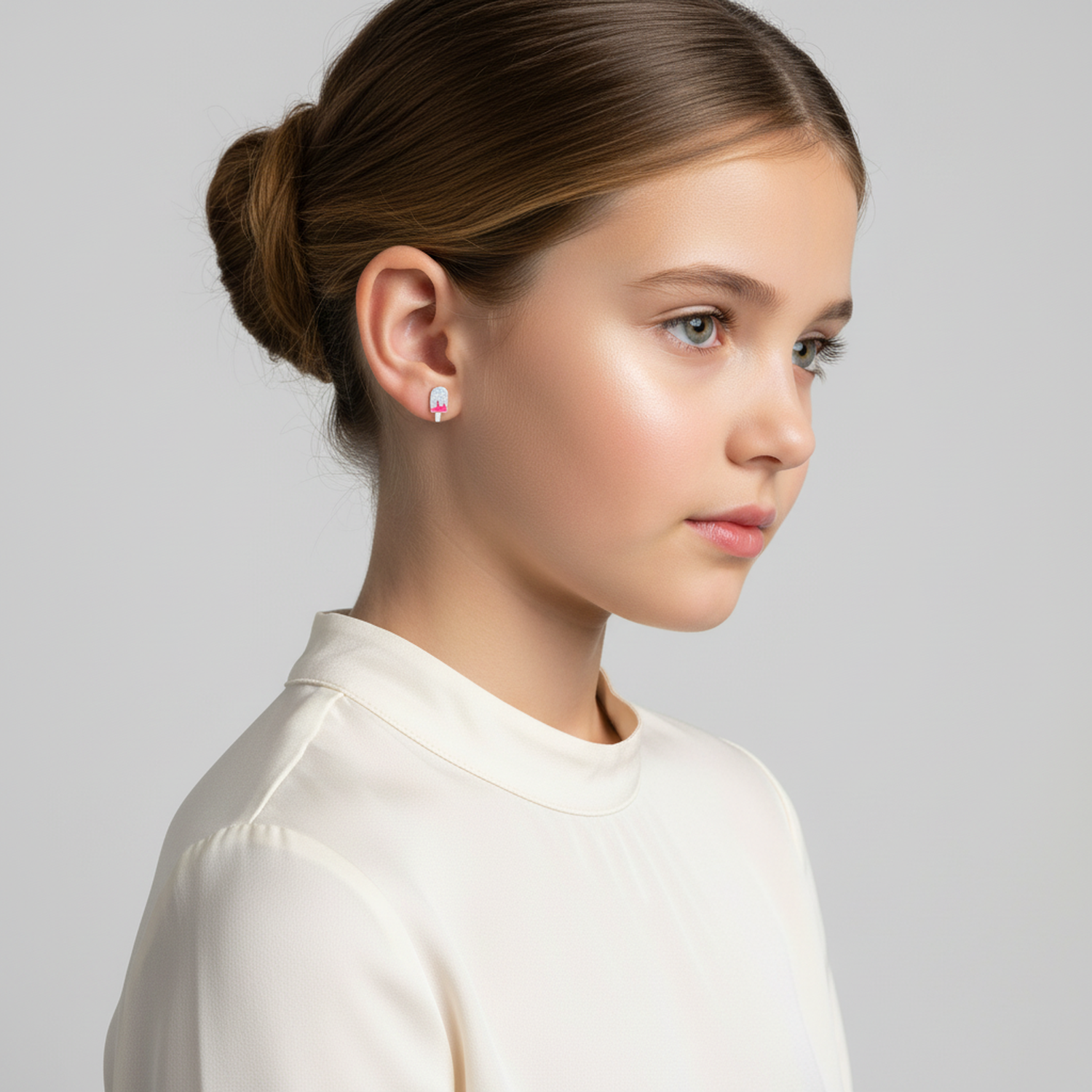 Melchior Jewellery glitter ice cream ear studs for kids worn by a girl with hair tied back