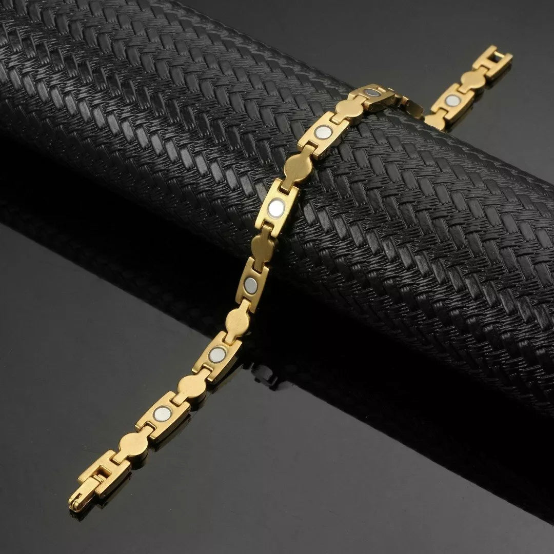 Gold healing magnetic bracelet for women by Melchior Jewellery on black textured display