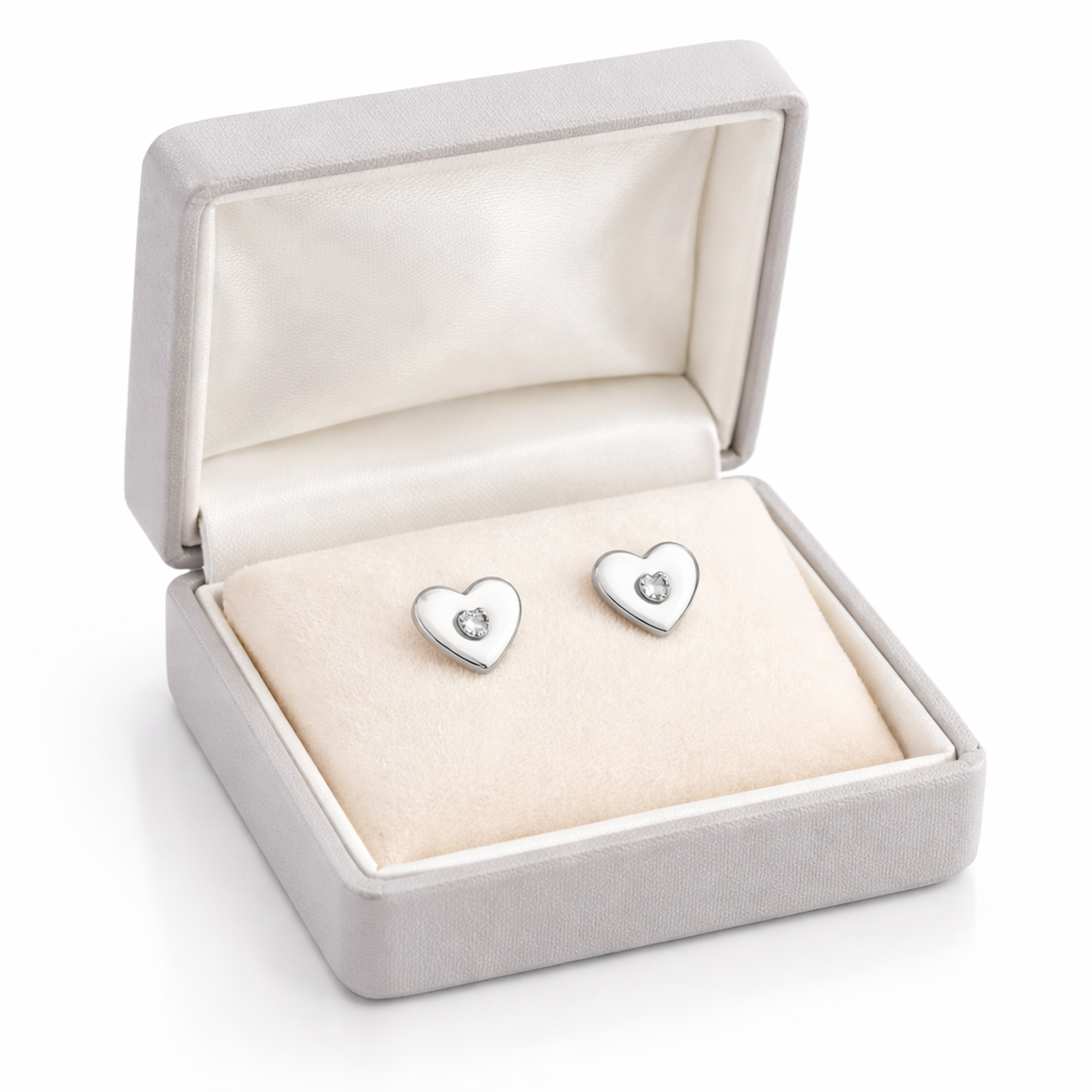 Melchior Jewellery heart shaped earrings for girls in silver with a small central gem in a cream display box