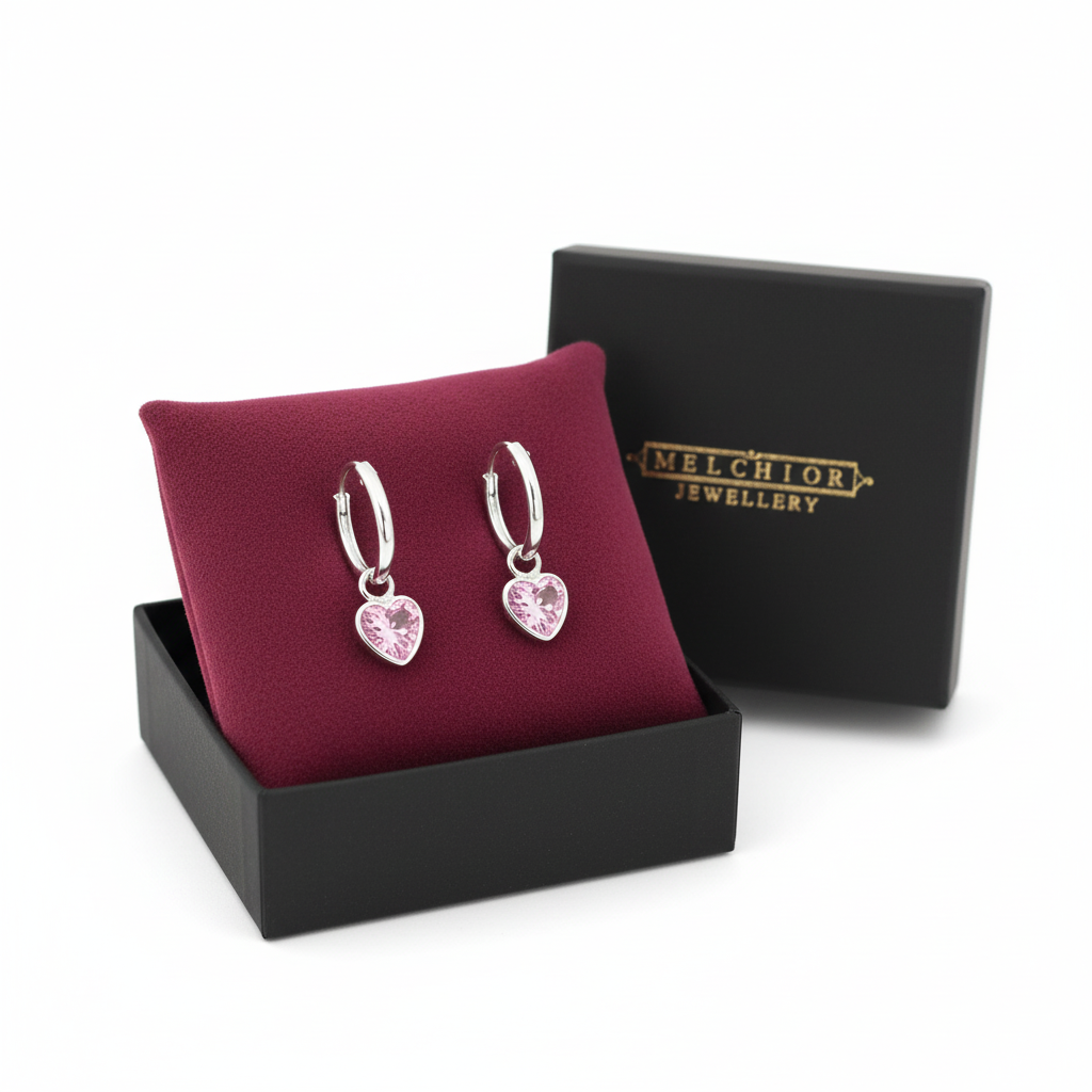 Heart-shaped silver earrings for children with pink stones by Melchior Jewellery in black gift box