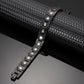 Melchior Jewellery black titanium magnetic bracelet for women displayed on textured black surface with link design and magnets