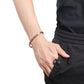 Melchior Jewellery ladies copper magnetic bracelet on wrist with braided copper links styled with black outfit and hand in pocket