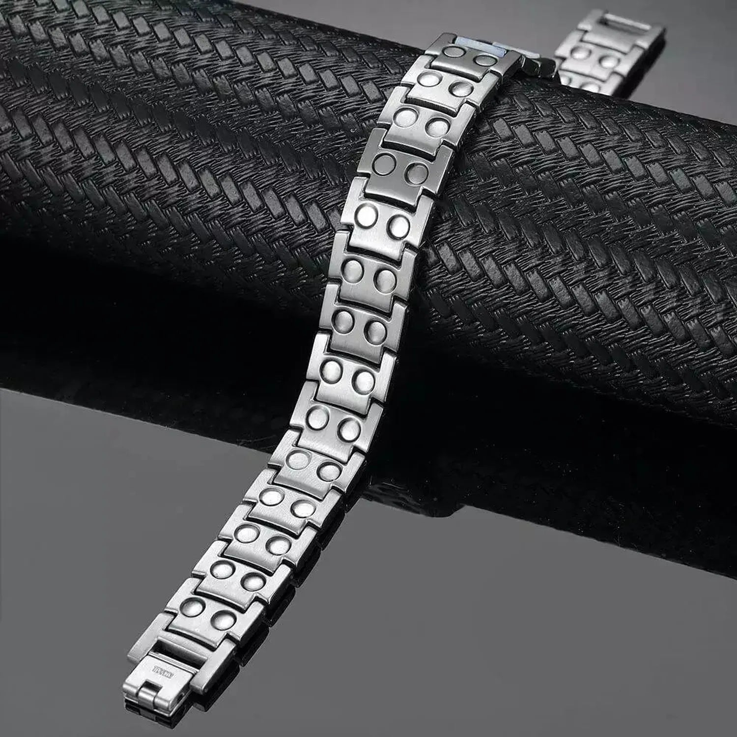 Melchior Jewellery silver titanium magnetic bracelet with modern dotted link design on black display