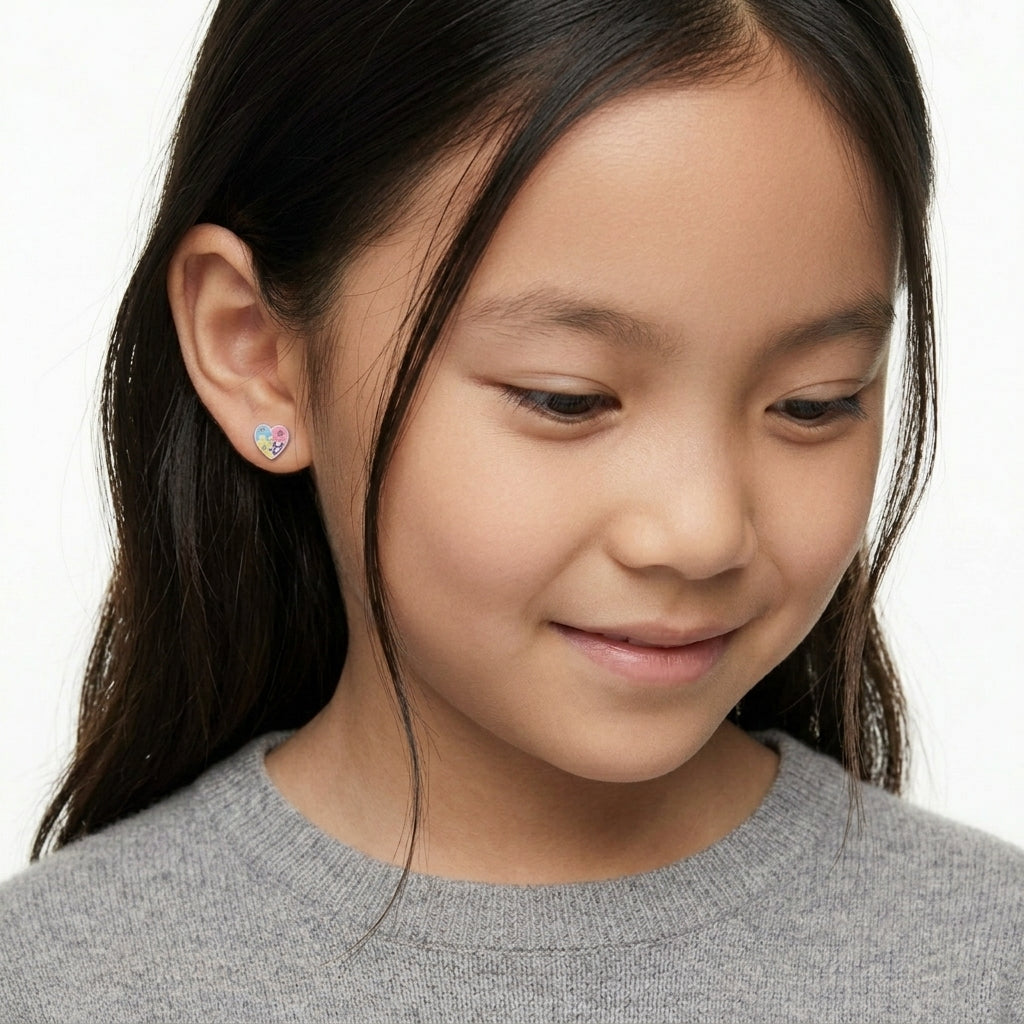 Melchior Jewellery Jigsaw Heart Stud Earrings in pastel pink and blue worn by young girl with long dark hair