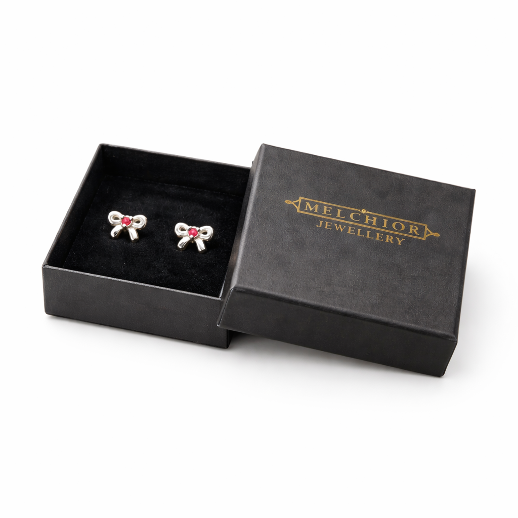 Melchior Jewellery July birthstone earrings for kids with red stones in silver bow design in black gift box