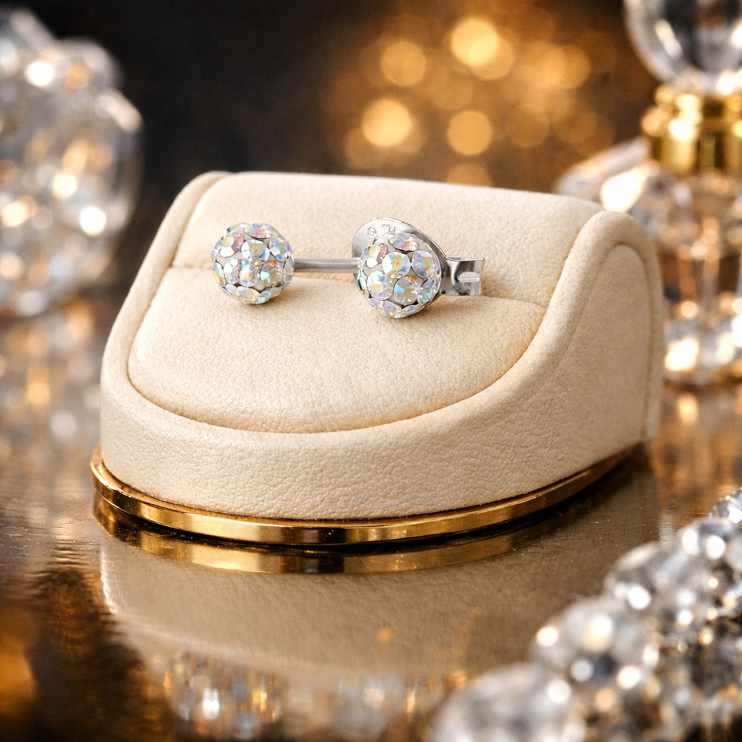 Melchior Jewellery kids AB crystal stud earrings displayed on a cream velvet stand with a gold base
