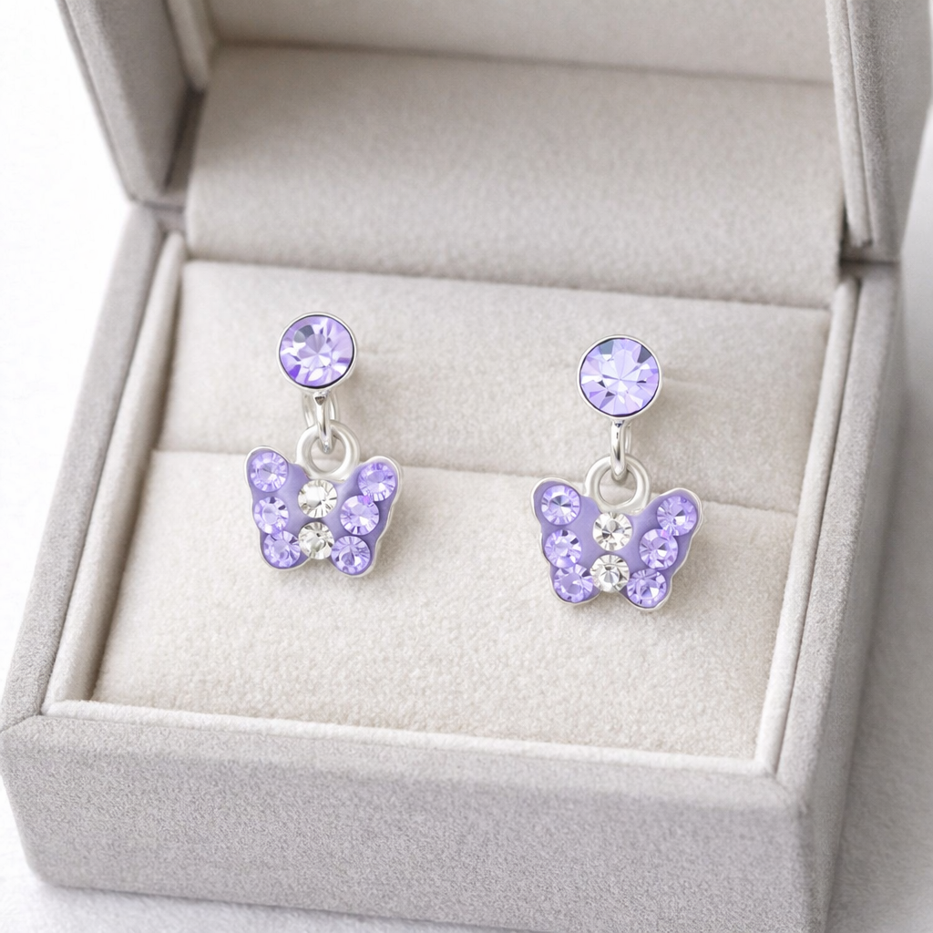Melchior Jewellery kids lilac drop earrings with butterfly design and lilac crystals in grey velvet box