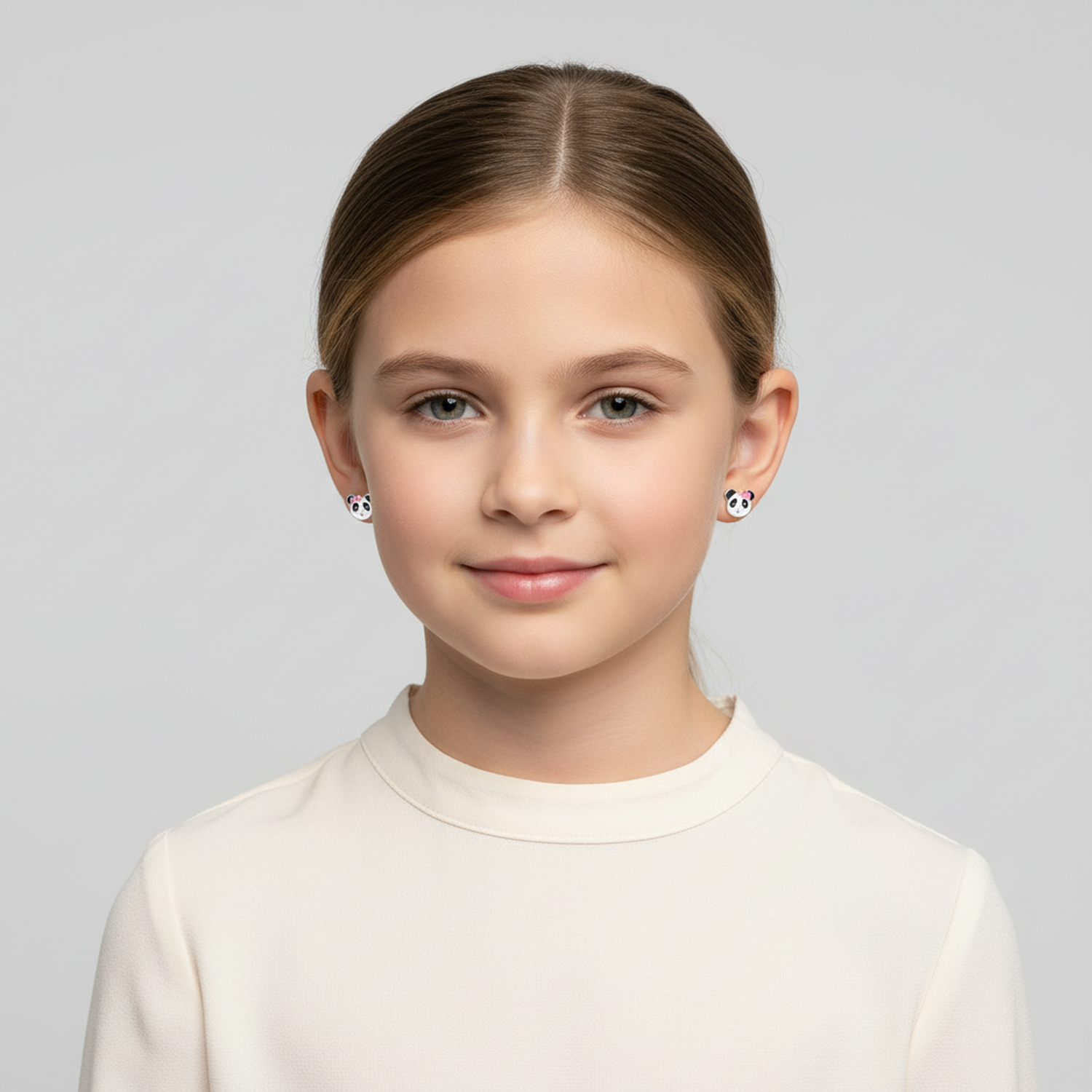 Girl wearing kids panda bear stud earrings from Melchior Jewellery with white and black panda design