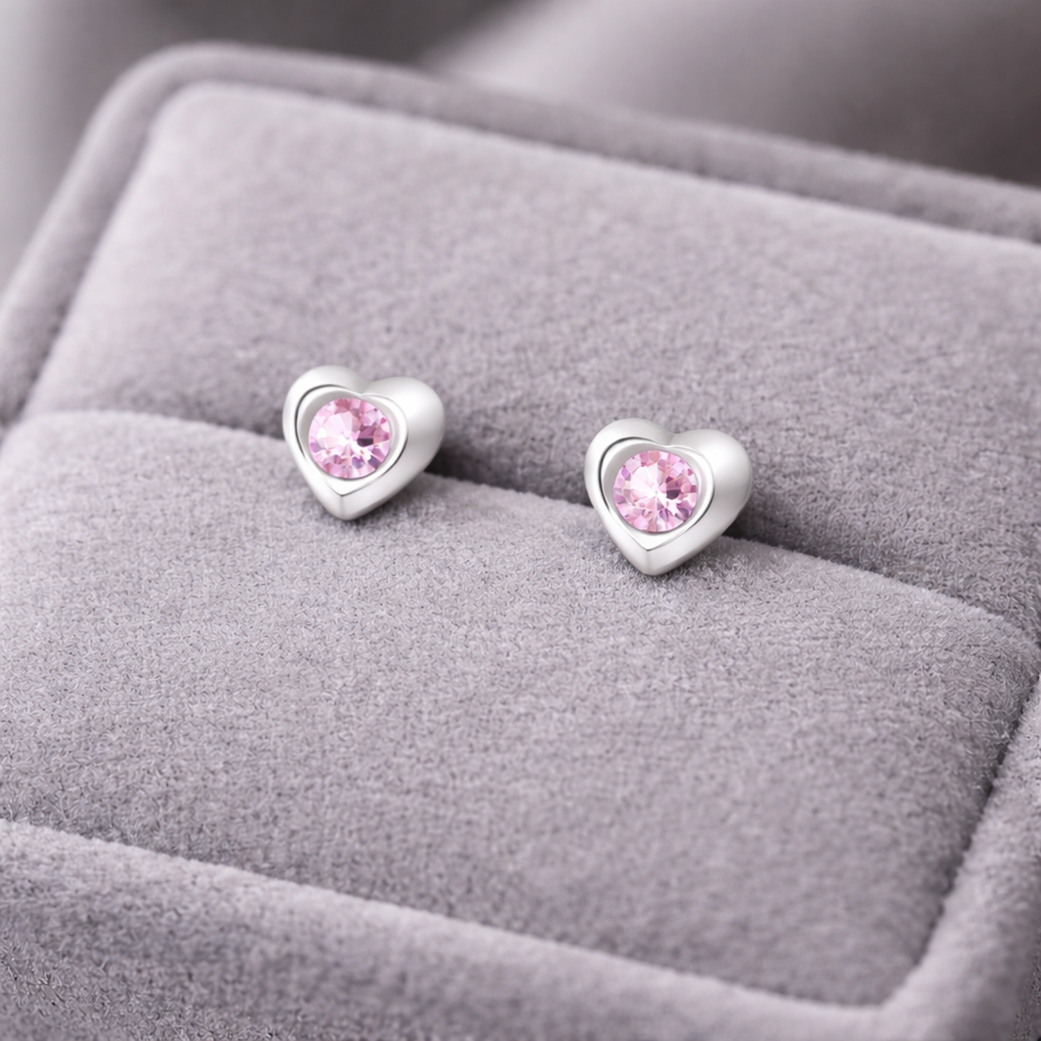 Melchior Jewellery kids pink crystal stud earrings in heart-shaped silver setting on grey velvet