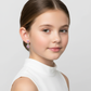 Young girl wearing Melchior Jewellery kids silver heart drop earrings with pink stones