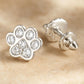 Melchior Jewellery kids sterling silver paw earrings with sparkling stones on beige background