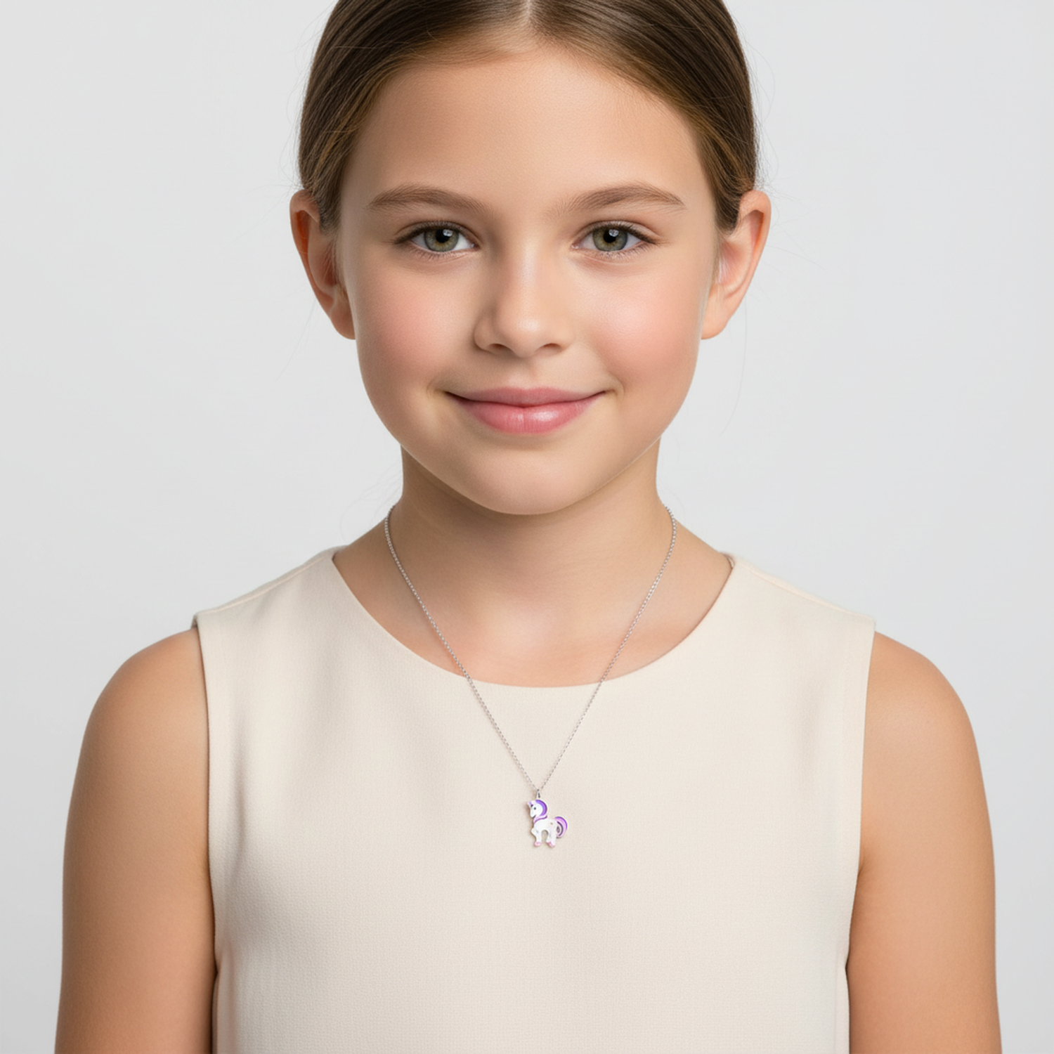 Child wearing Melchior Jewellery kids unicorn pendant silver necklace with purple details on a silver chain