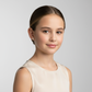 Young girl wearing Melchior Jewellery kids white pearl stud earrings with a subtle smile