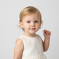 Toddler wearing kids white pearl stud earrings by Melchior Jewellery in white dress