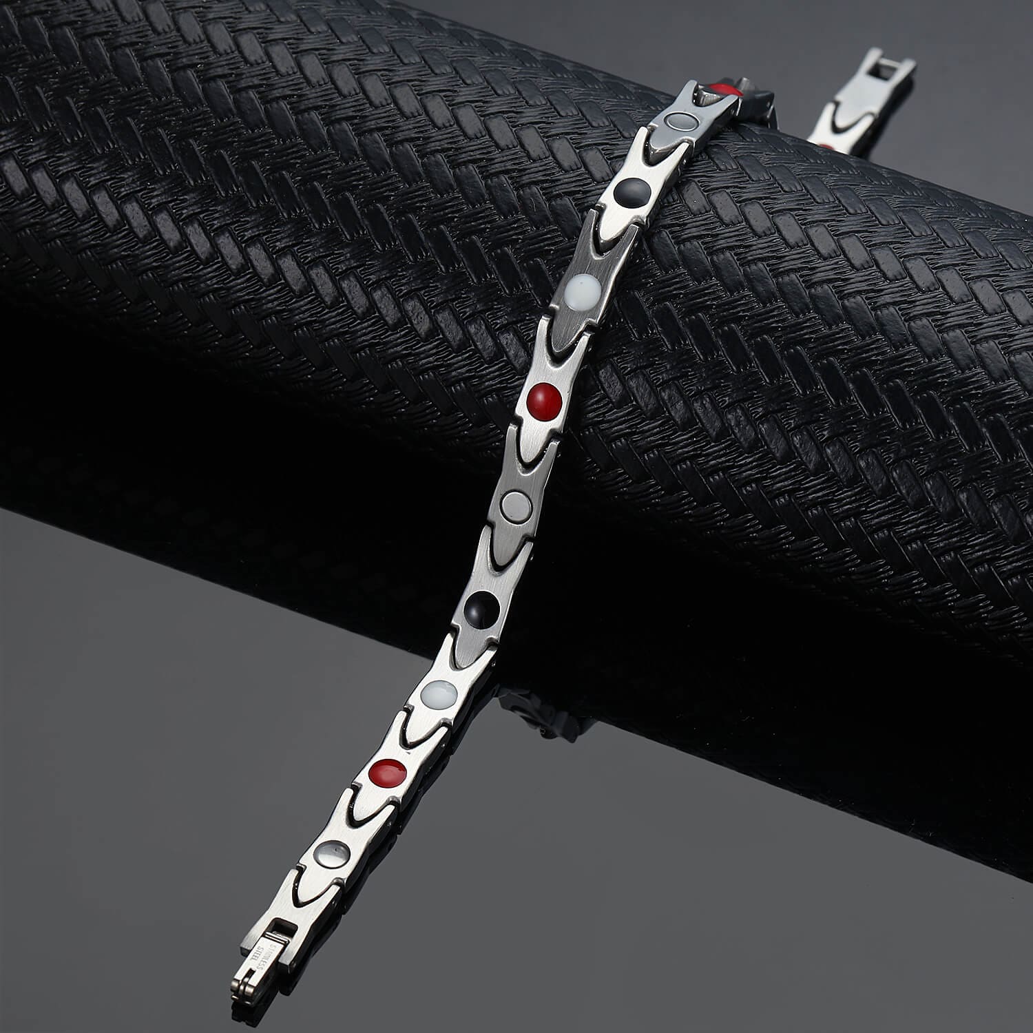 Melchior Jewellery ladies silver titanium magnetic bracelet with red black and white inlays on black display