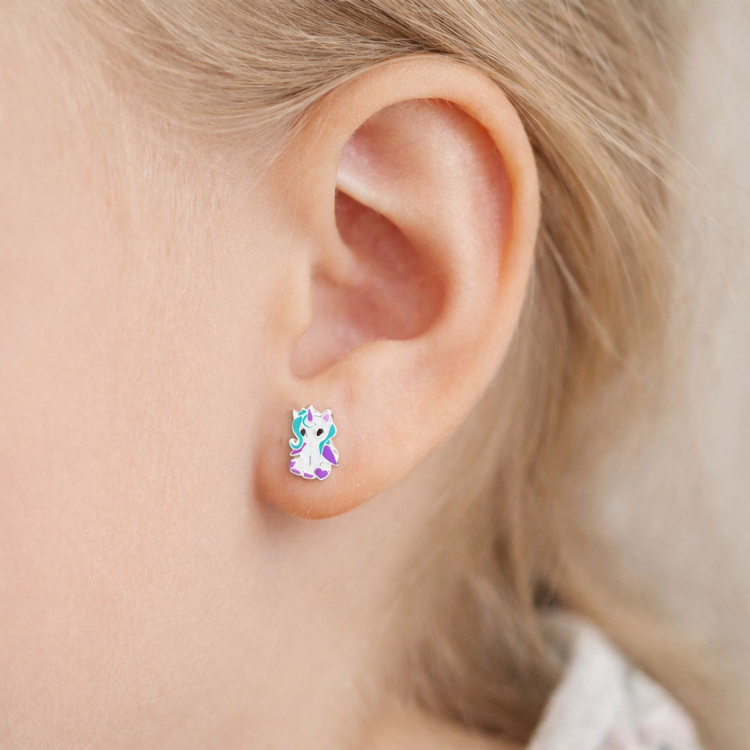 Melchior Jewellery little girls unicorn studs worn on ear in close up for childrens earrings