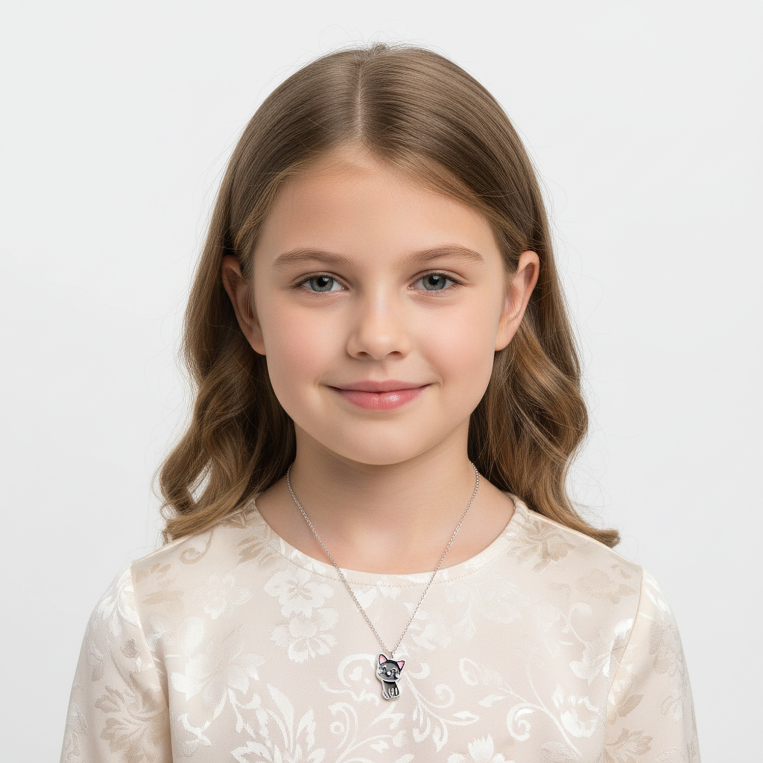 Melchior Jewellery lucky cat necklace for kids worn by smiling girl with light brown hair
