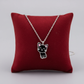 Melchior Jewellery lucky cat necklace for kids with silver chain and black cat pendant on red cushion