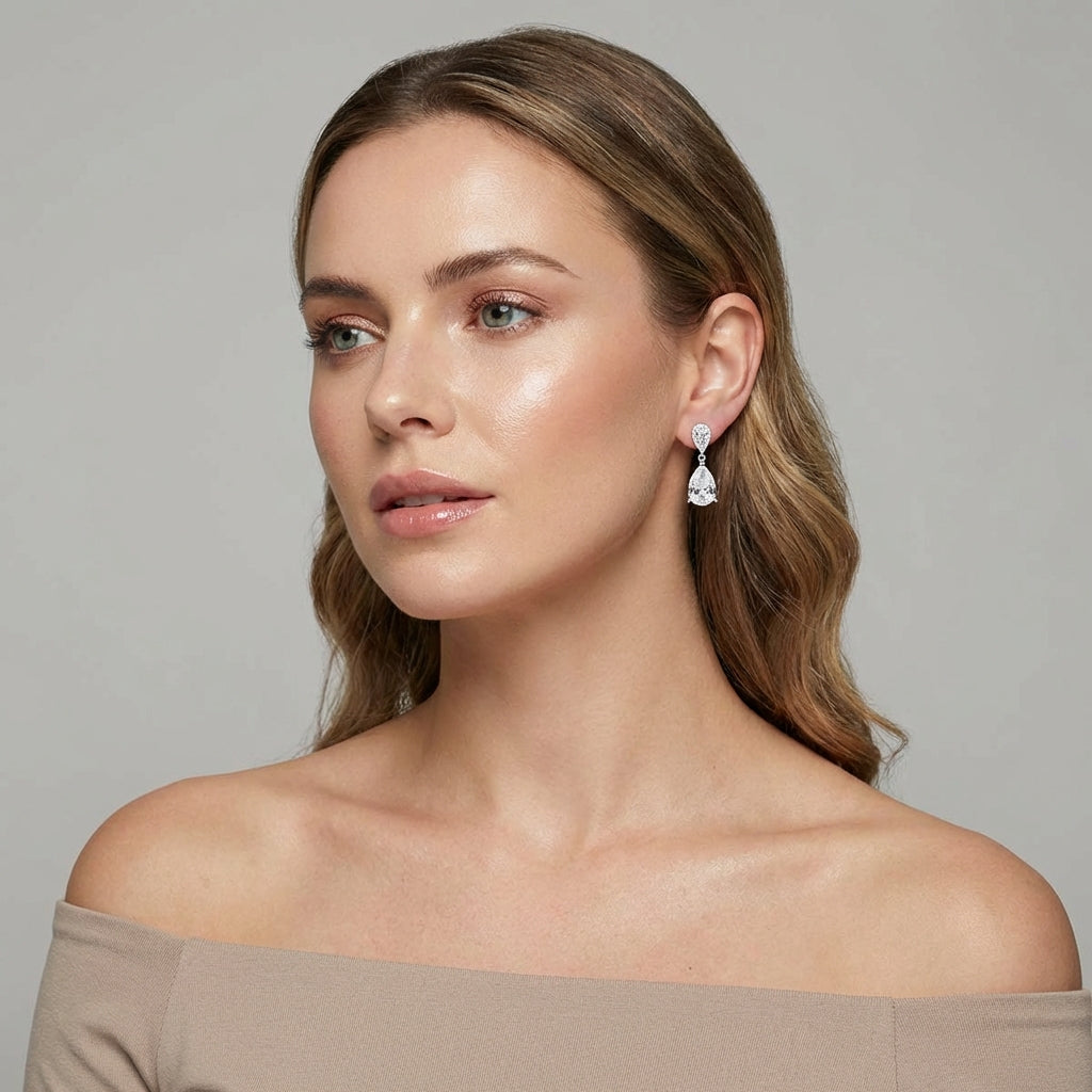 Melchior Jewellery luna wedding earrings for brides worn by woman with light brown hair and off shoulder top