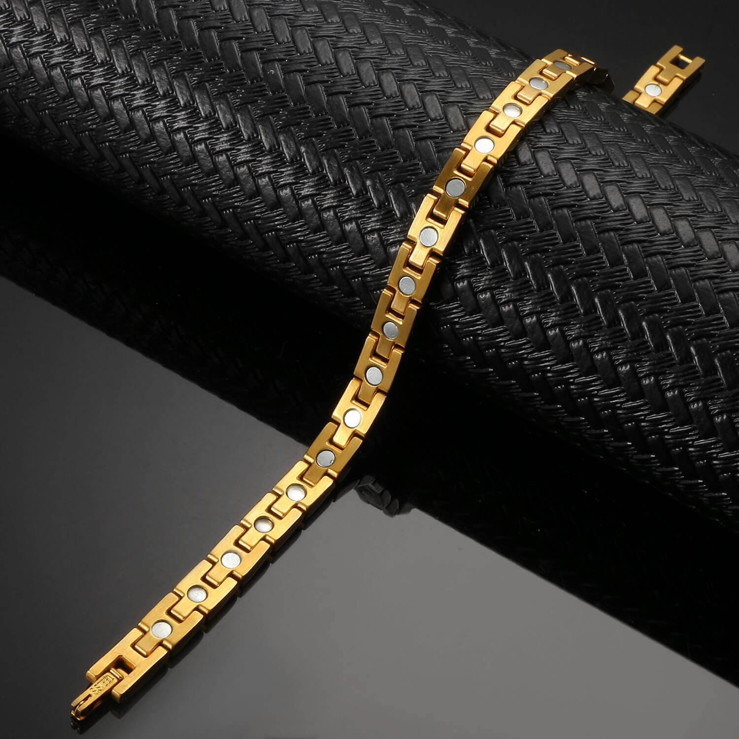 Melchior Jewellery gold magnetic bracelet for arthritis pain relief with silver magnets on black textured display