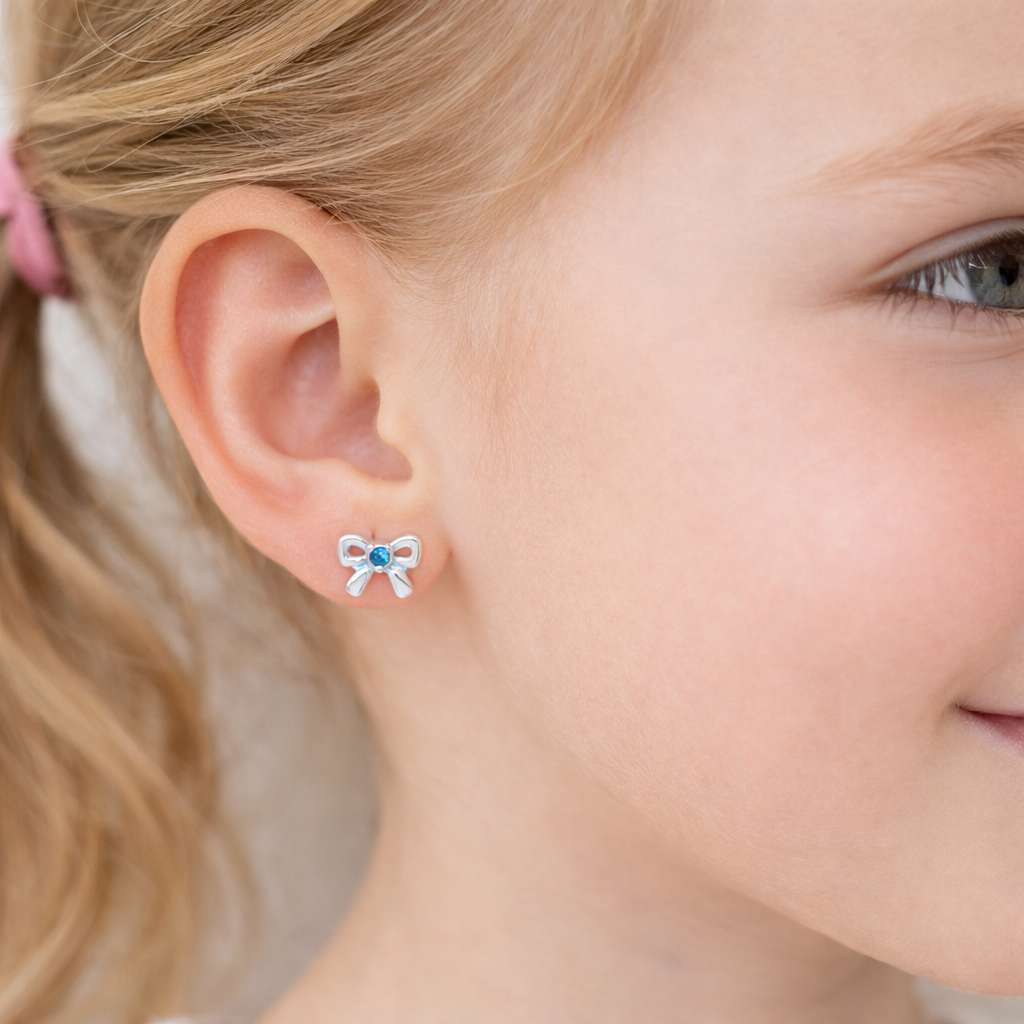 Melchior Jewellery March birthstone earrings for kids shaped like silver bows with blue stones