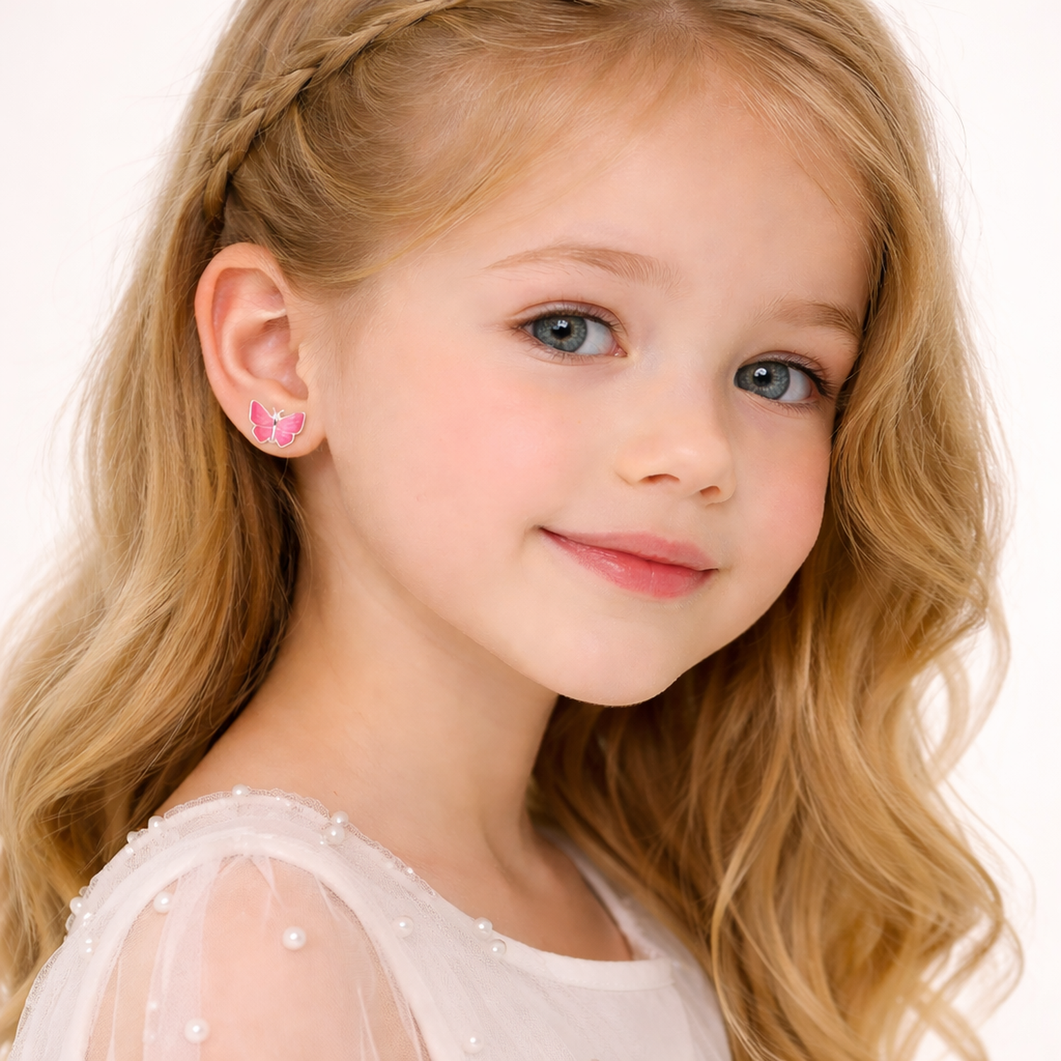 Melchior Jewellery pink butterfly stud earrings for kids worn by young girl with blonde hair
