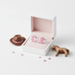 Pink cowboy boots stud earrings for children displayed in white box with cowboy hat and horse toys