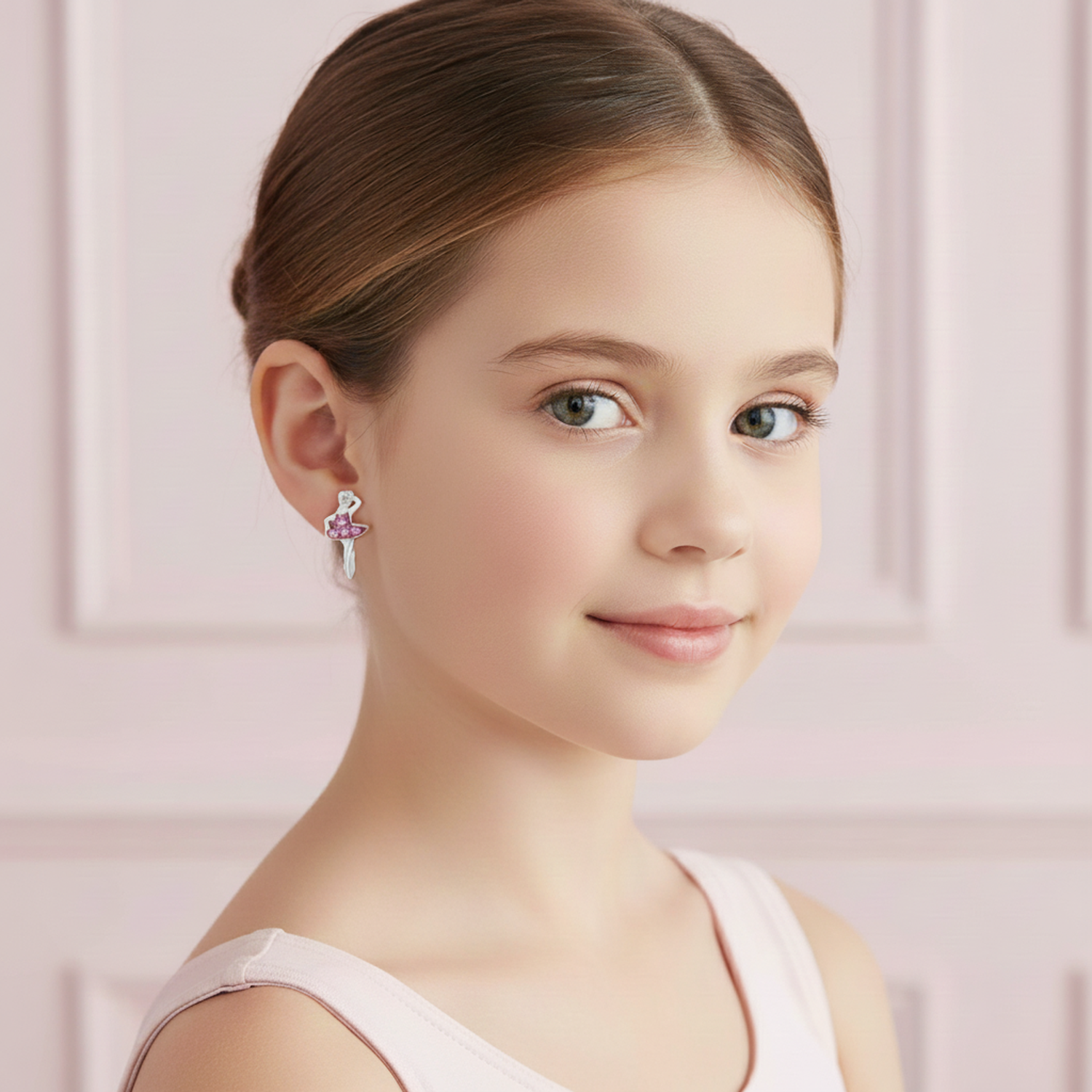 Girl wearing Melchior Jewellery pink crown ballet shoes earrings with a delicate ballet shoe design