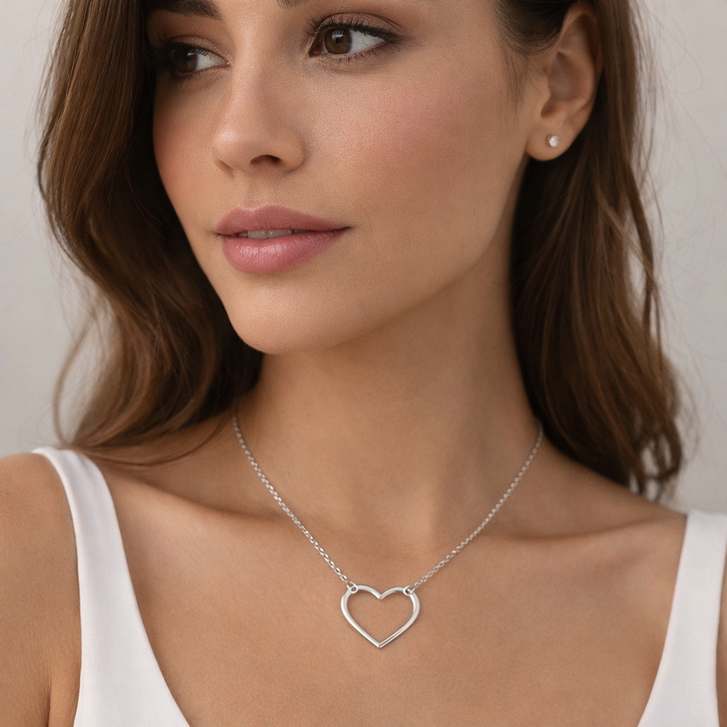 Melchior Jewellery womans necklace with rhodium plated heart pendant on model wearing white top