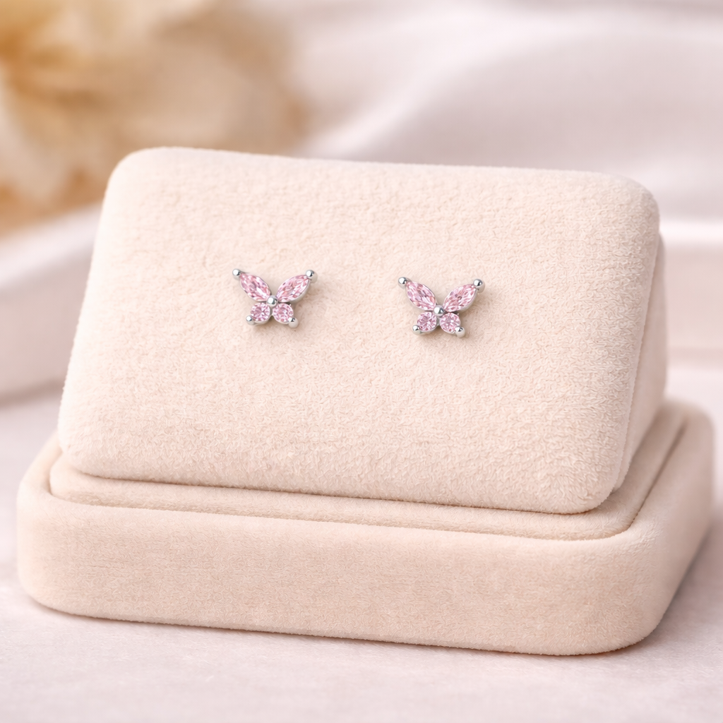 Melchior Jewellery pink butterfly screw back earrings for girls with sparkling stones on beige display