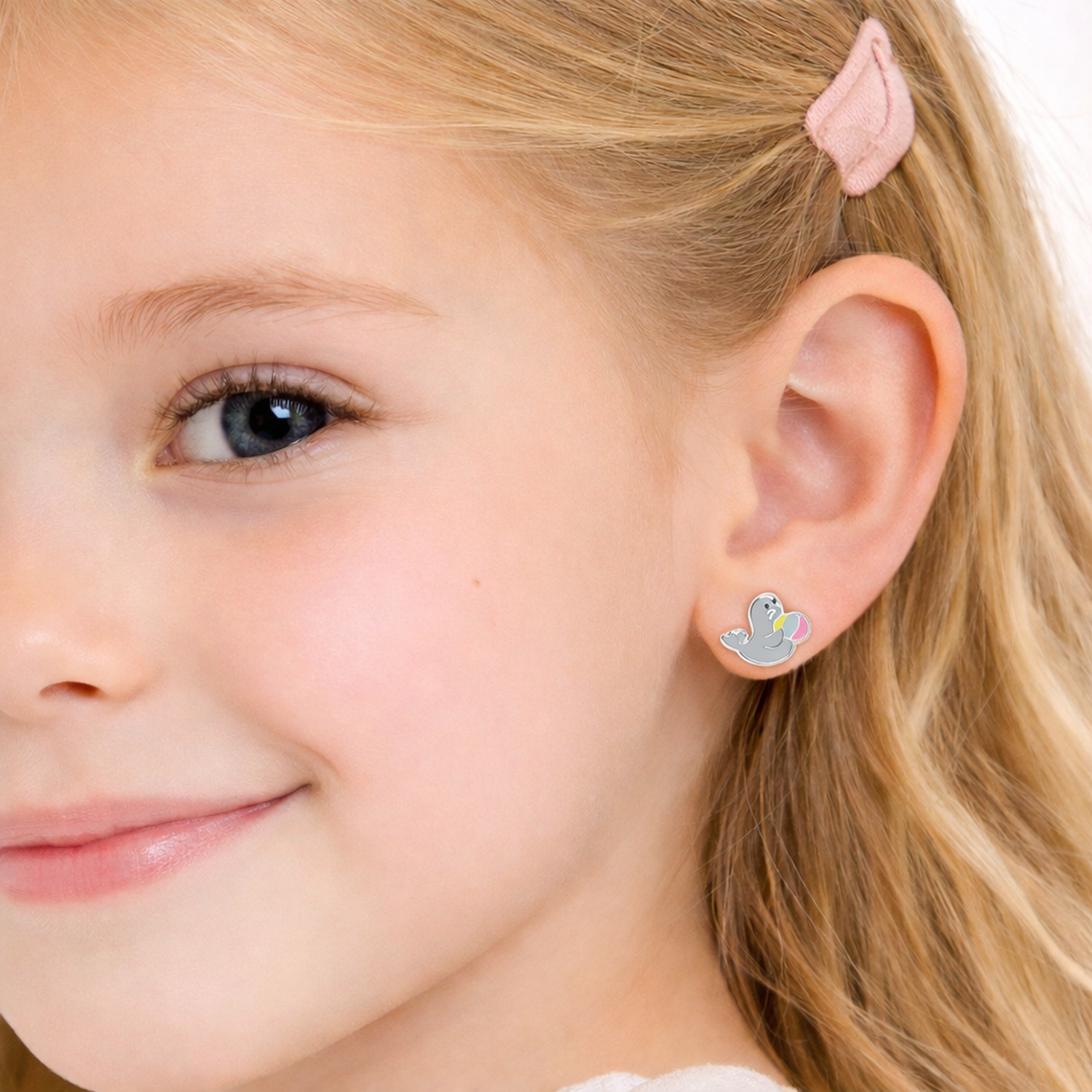 Melchior Jewellery seal stud earrings for girls worn by young girl with blonde hair and pink hairclip