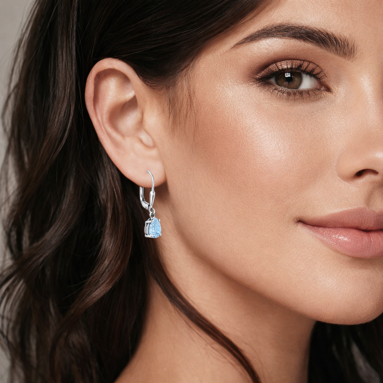 Silver Aqua Bridal Teardrop Leverback Earrings worn by woman showcasing delicate blue gemstone design