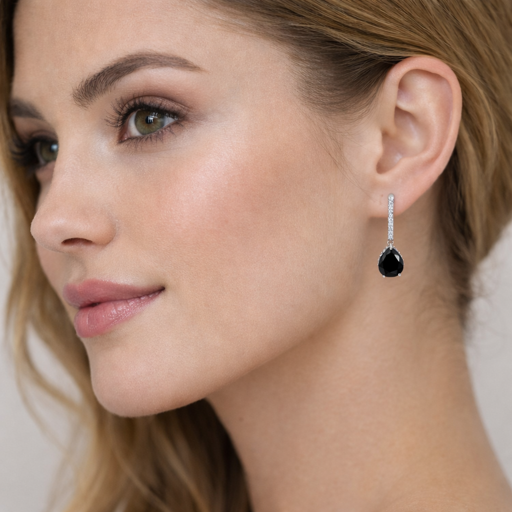 Melchior Jewellery silver black onyx halo drop earrings worn by woman with fair skin and light brown hair