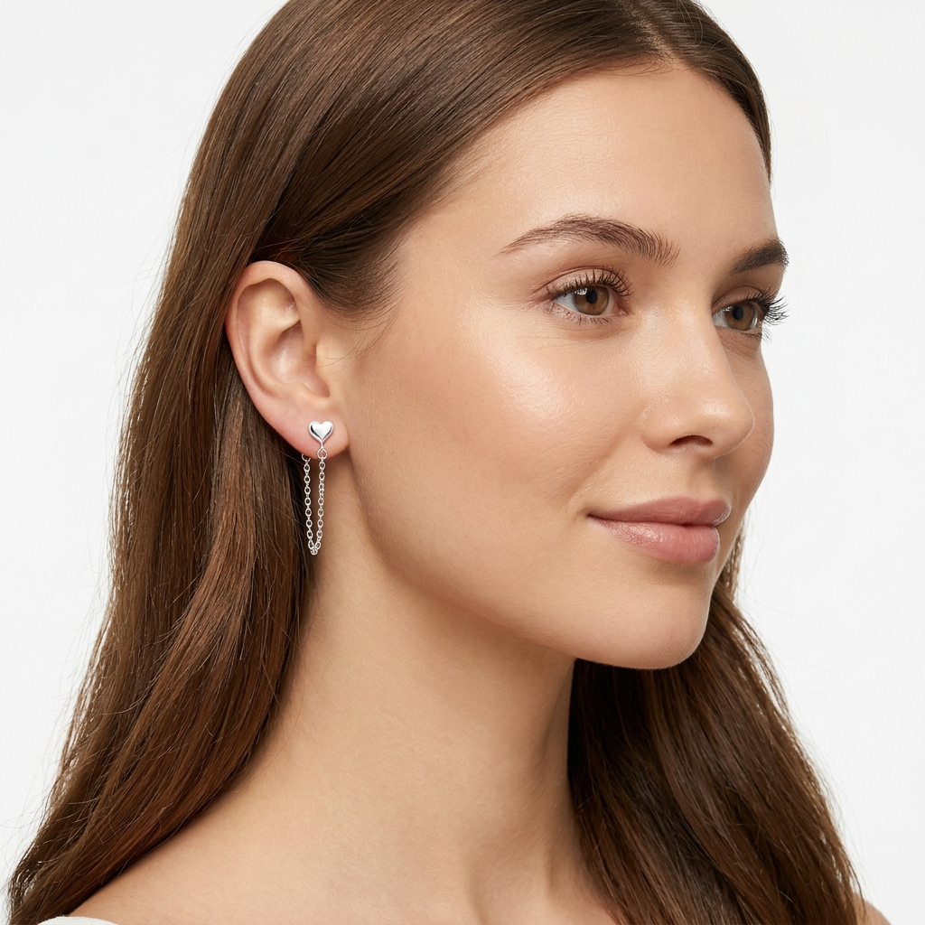 Silver Heart Stud Chain Earrings in sterling silver worn by woman with long brown hair