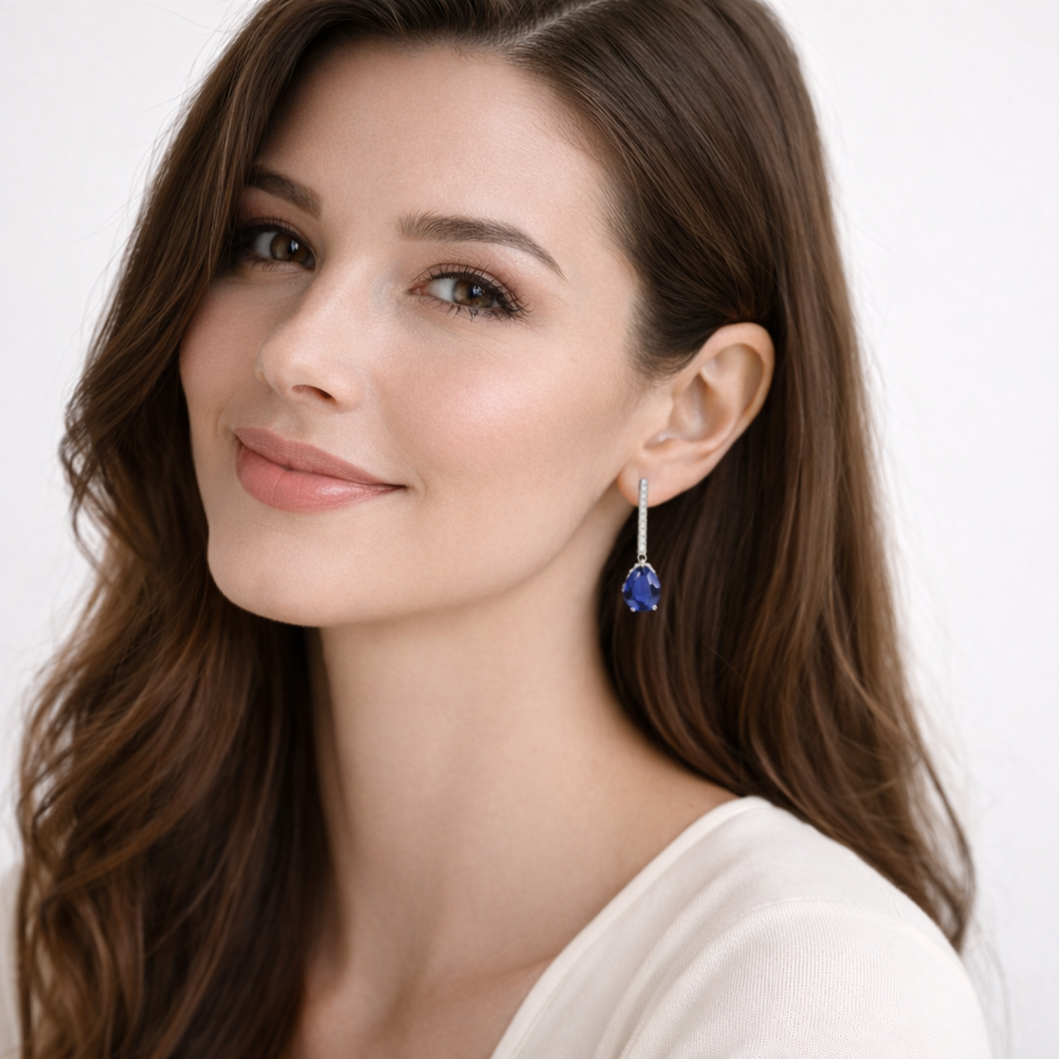 Woman wearing Silver Sapphire September Birthstone Earrings by Melchior Jewellery with blue sapphire drops