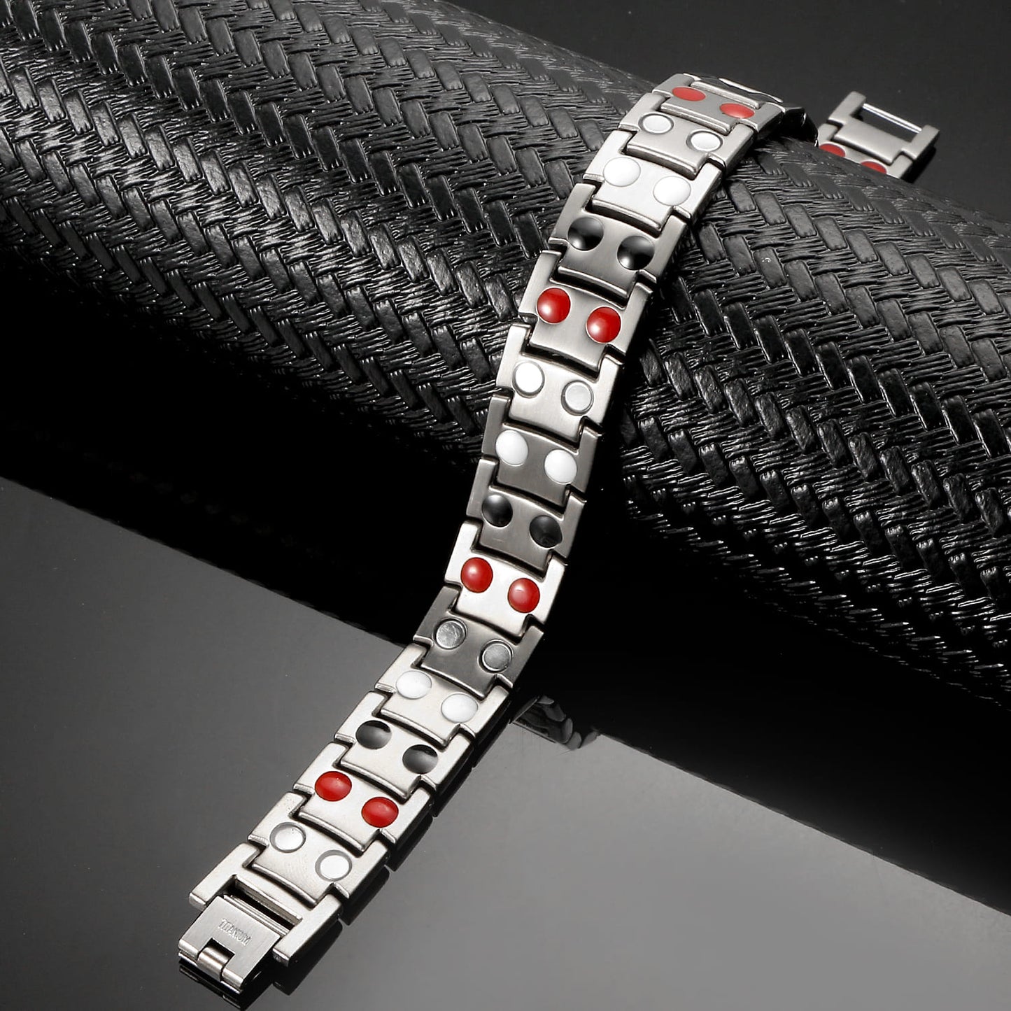 Melchior Jewellery silver titanium magnetic bracelet with red and white accents on black textured display