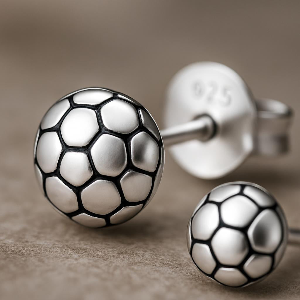 Small Football Stud Earrings Earrings For Kids by Melchior Jewellery in silver finish with detailed football pattern