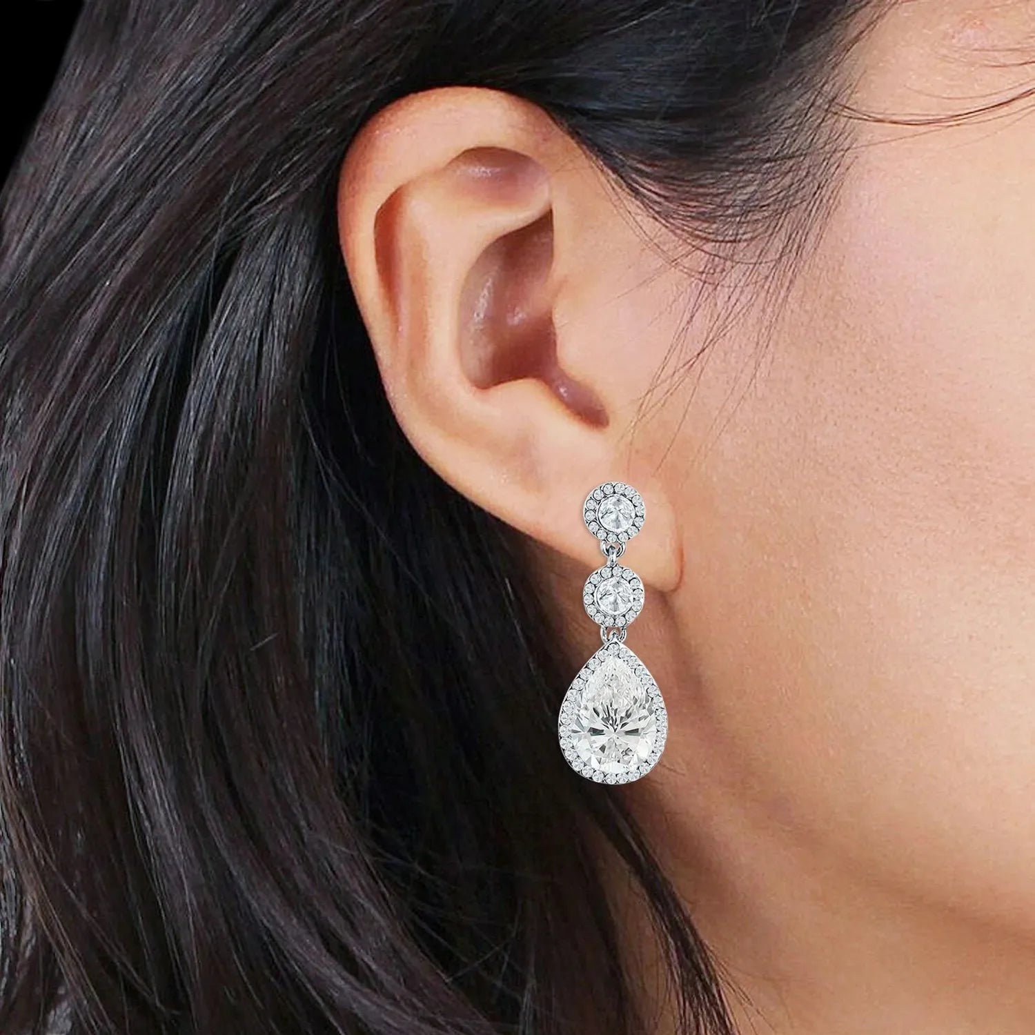Melchior Jewellery Sterling Silver Aurora Halo Drop Earrings worn by woman with dark hair