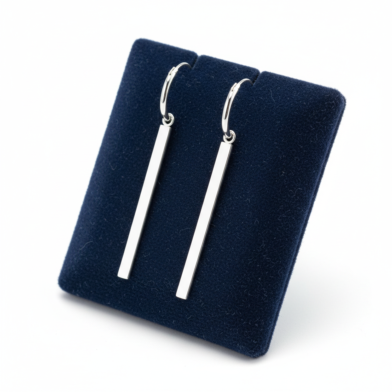 Melchior Jewellery sterling silver bar charm hoop earrings displayed on navy blue stand