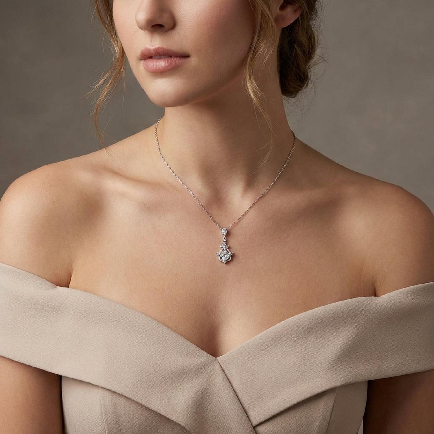 Sterling silver bridal necklace from Melchior Jewellery worn by woman in off-shoulder beige dress
