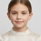 Young girl wearing sterling silver cross stud earrings for kids from Melchior Jewellery with a cream satin top