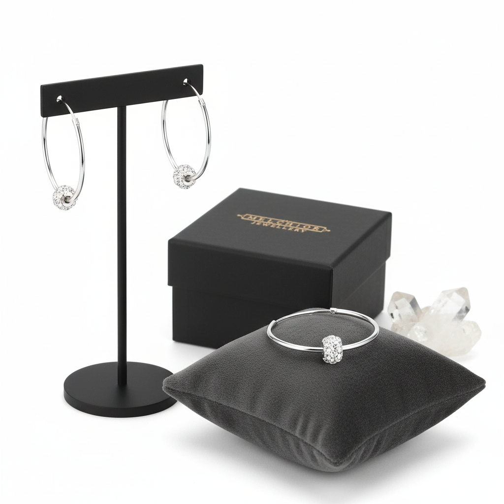 Melchior Jewellery sterling silver crystal hoop earrings displayed with matching ring and black box