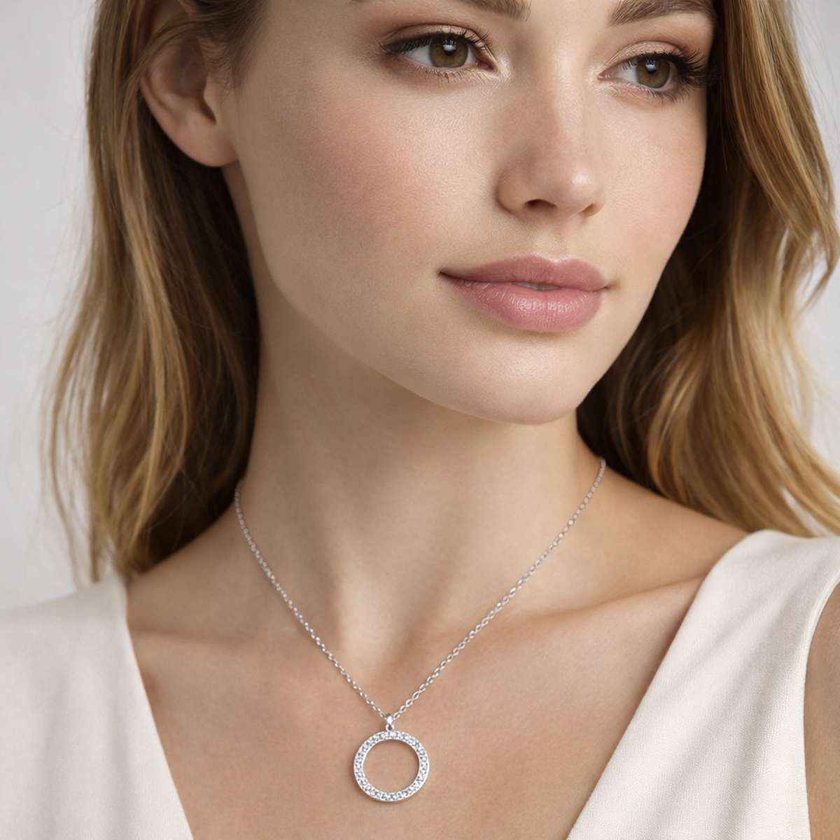Woman wearing Melchior Jewellery sterling silver cubic zirconia necklace with circular pendant